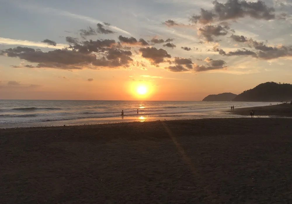 Golden sunset over the rocky cove and Pacific shoreline at Playa Pelada, Costa Rica